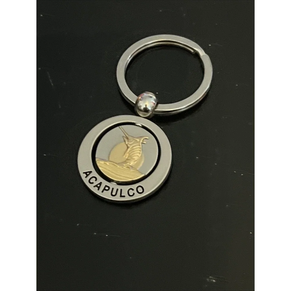 round metal Acapulco souvenir keychain featuring a sailfish design